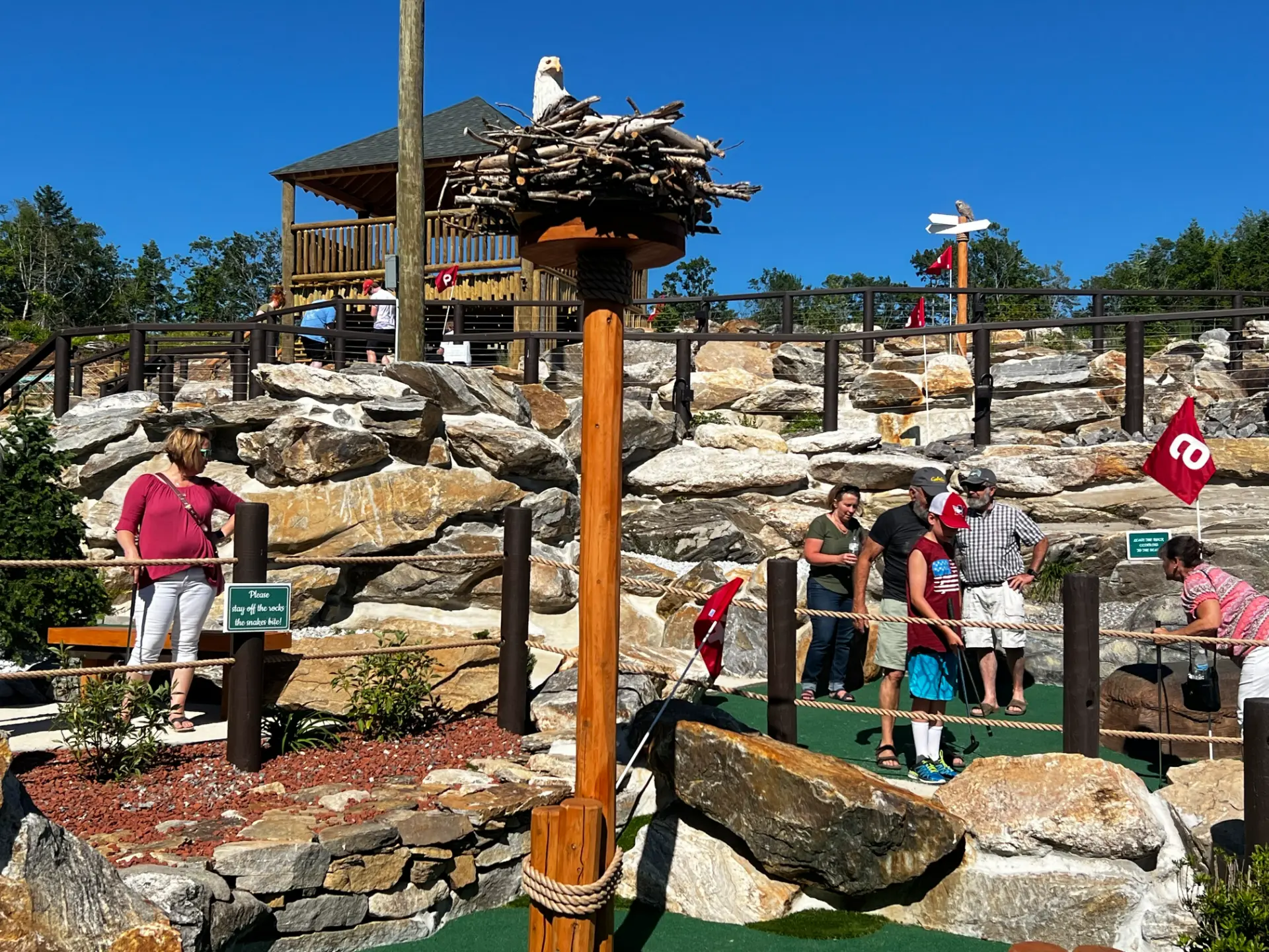 A group of people standing around in the middle of an area.